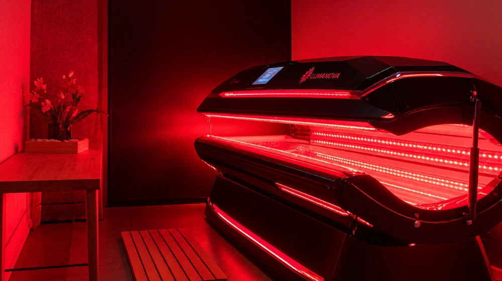 Red light therapy bed with red LED lights in a wellness room